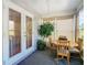 Bright sun room with a view of the exterior, table with four chairs, and an indoor tree at 11247 Corey Pavin Ln, San Antonio, FL 33576
