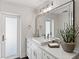Bright bathroom features a large mirror, a vessel sink and contemporary lighting at 2049 Massachusetts Ne Ave, St Petersburg, FL 33703