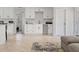 Open concept kitchen with white cabinets, wine glass rack and view to the bedroom at 2049 Massachusetts Ne Ave, St Petersburg, FL 33703