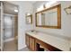 Bathroom with wood vanity, large mirror, and shower at 6269 Palma Del Mar S Blvd # 608, St Petersburg, FL 33715