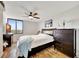 Bright bedroom with hardwood floors, a ceiling fan, and a dresser at 6269 Palma Del Mar S Blvd # 608, St Petersburg, FL 33715