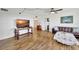 Living room featuring hardwood floors, a large TV, and ample natural light at 6269 Palma Del Mar S Blvd # 608, St Petersburg, FL 33715