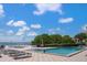Inviting pool area with lounge chairs and water view at 5700 Escondida S Blvd # 306, St Petersburg, FL 33715