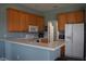 Kitchen boasts wood cabinets, granite countertops and stainless steel appliances at 10312 Cleghorn Dr, San Antonio, FL 33576