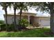 One-story house with palm trees and a well-maintained lawn at 10312 Cleghorn Dr, San Antonio, FL 33576