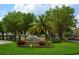 Tampa Bay Golf and Country Club entrance, lush landscaping, and palm trees at 10312 Cleghorn Dr, San Antonio, FL 33576