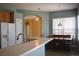 Kitchen with breakfast bar, wood cabinets, and tile flooring at 10312 Cleghorn Dr, San Antonio, FL 33576