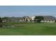 Large clubhouse with pond and golf course in the background at 10312 Cleghorn Dr, San Antonio, FL 33576