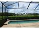 Screened-in pool with a view of the golf course at 10312 Cleghorn Dr, San Antonio, FL 33576