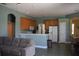 Open kitchen features wood cabinets, a breakfast bar, and tile floors at 10312 Cleghorn Dr, San Antonio, FL 33576