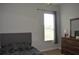 Bedroom with dresser, window with blinds and neutral colored walls at 10312 Cleghorn Dr, San Antonio, FL 33576