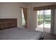 Main bedroom with access to the pool and a large bed at 10312 Cleghorn Dr, San Antonio, FL 33576