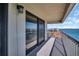 Spacious balcony featuring a metal railing and serene views of the water and nearby buildings at 1651 Sand Key Estates Ct # 74, Clearwater Beach, FL 33767