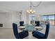 Stylish dining room featuring a glass table, modern chairs, and ample natural light at 1651 Sand Key Estates Ct # 74, Clearwater Beach, FL 33767