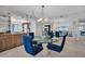 Dining room features glass table, blue chairs, and bar with mirrored walls at 1651 Sand Key Estates Ct # 74, Clearwater Beach, FL 33767