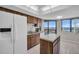 Kitchen featuring white appliances, a center island, wood cabinets, and a beautiful view at 1651 Sand Key Estates Ct # 74, Clearwater Beach, FL 33767