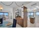 Bright kitchen with wood accents, a sink, and a large opening leading to a living area at 1651 Sand Key Estates Ct # 74, Clearwater Beach, FL 33767