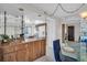 Kitchen area with dark wood cabinets, a sink, and a view into the dining area at 1651 Sand Key Estates Ct # 74, Clearwater Beach, FL 33767
