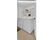 Functional laundry room with white washer and dryer and wire shelving at 1651 Sand Key Estates Ct # 74, Clearwater Beach, FL 33767