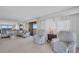 Spacious living room with large windows and comfortable seating, perfect for relaxation at 1651 Sand Key Estates Ct # 74, Clearwater Beach, FL 33767