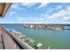 Scenic water view from the balcony, showcasing boats, docks, and waterfront homes under a blue sky at 1651 Sand Key Estates Ct # 74, Clearwater Beach, FL 33767