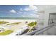 Condo balcony view overlooking the beach, Gulf of Mexico, pool, and manicured grounds at 5830 Midnight Pass Rd # 705, Sarasota, FL 34242