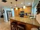 Bright kitchen featuring tiled floor, wood cabinets, granite countertops, and stainless steel appliances at 5830 Midnight Pass Rd # 705, Sarasota, FL 34242