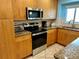Kitchen with stainless steel oven, granite countertops and wood cabinets at 5830 Midnight Pass Rd # 705, Sarasota, FL 34242