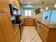 Updated kitchen features wood cabinets, granite countertops, and stainless steel appliances at 5830 Midnight Pass Rd # 705, Sarasota, FL 34242