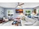 Bright living room features a comfy sectional sofa, large windows, and ceiling fan at 4984 Oxford N Ave, St Petersburg, FL 33710