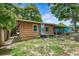 House exterior showcasing a side view, backyard, and covered patio at 4984 Oxford N Ave, St Petersburg, FL 33710