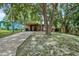Charming house with a long driveway and lush trees at 4984 Oxford N Ave, St Petersburg, FL 33710