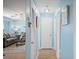 Light blue hallway with tile floors and access to living room at 5830 Midnight Pass Rd # 705, Sarasota, FL 34242