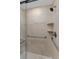 Walk-in shower with grab bars and tiled walls at 5830 Midnight Pass Rd # 705, Sarasota, FL 34242