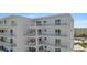 White building exterior with multiple balconies at 5830 Midnight Pass Rd # 705, Sarasota, FL 34242