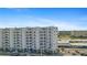 White building exterior with multiple balconies and ocean view at 5830 Midnight Pass Rd # 705, Sarasota, FL 34242