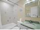 Clean bathroom with a bathtub and green vanity at 5830 Midnight Pass Rd # 705, Sarasota, FL 34242