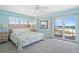 Primary bedroom with king bed and balcony access at 5830 Midnight Pass Rd # 705, Sarasota, FL 34242