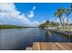 Peaceful waterfront view with a wooden dock and lush greenery at 1301 48Th Ne Ave, St Petersburg, FL 33703