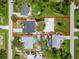 An aerial view shows a property with a well-maintained lawn and clearly defined boundaries at 7162 Benson St, Englewood, FL 34224
