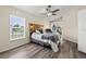 Bedroom with wood-look floors, ceiling fan, and sliding glass doors to the outdoor patio at 7162 Benson St, Englewood, FL 34224