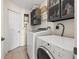 Bright laundry room with washer, dryer, and ample storage at 7162 Benson St, Englewood, FL 34224