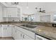 Modern kitchen with stainless steel appliances and granite countertops at 7162 Benson St, Englewood, FL 34224