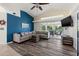 Spacious living room with L-shaped sofa and access to a patio at 7162 Benson St, Englewood, FL 34224