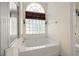 Bathroom with a bathtub and a large window at 7162 Benson St, Englewood, FL 34224