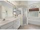 Bathroom with double vanity, shower, and separate tub at 7162 Benson St, Englewood, FL 34224
