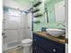 Updated bathroom with subway tile shower, wood vanity, and vessel sink at 7162 Benson St, Englewood, FL 34224
