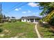 Spacious backyard with grassy area and home view at 7162 Benson St, Englewood, FL 34224