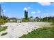 Large backyard with gravel area and storage buildings at 7162 Benson St, Englewood, FL 34224