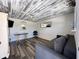 Cozy studio space with a sofa, desk, and wood-like flooring at 7162 Benson St, Englewood, FL 34224